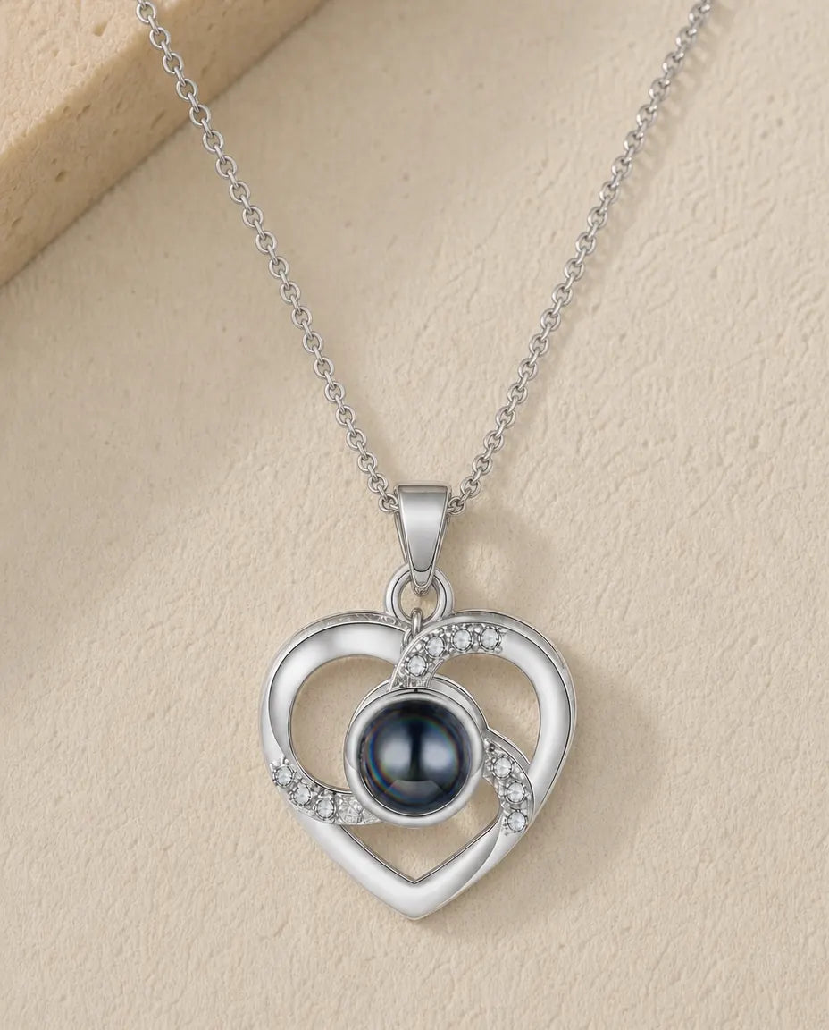 Personalised crystal heart photo projection necklace in silver, flat lay