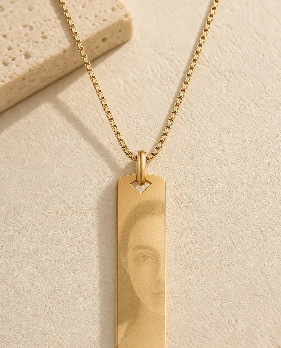 Gold vertical bar necklace with a photo etched into the metal