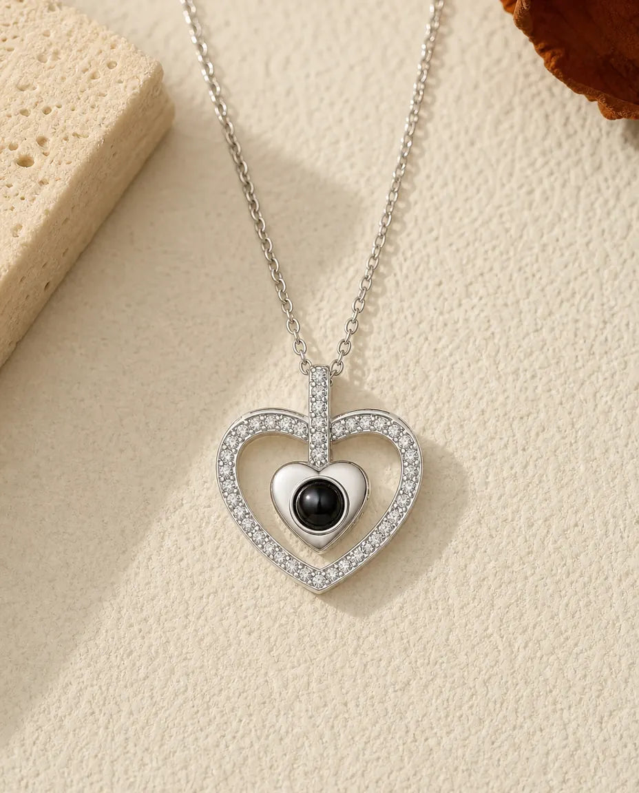 Double heart photo projection necklace in silver, pave crystal outer heart around a polished inner heart