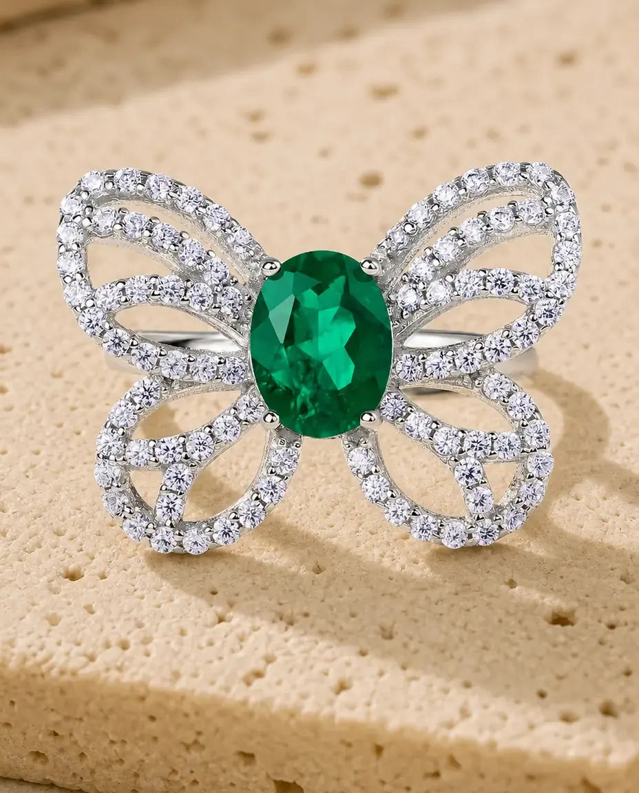 Lab emerald butterfly statement ring in sterling silver with open pave wings