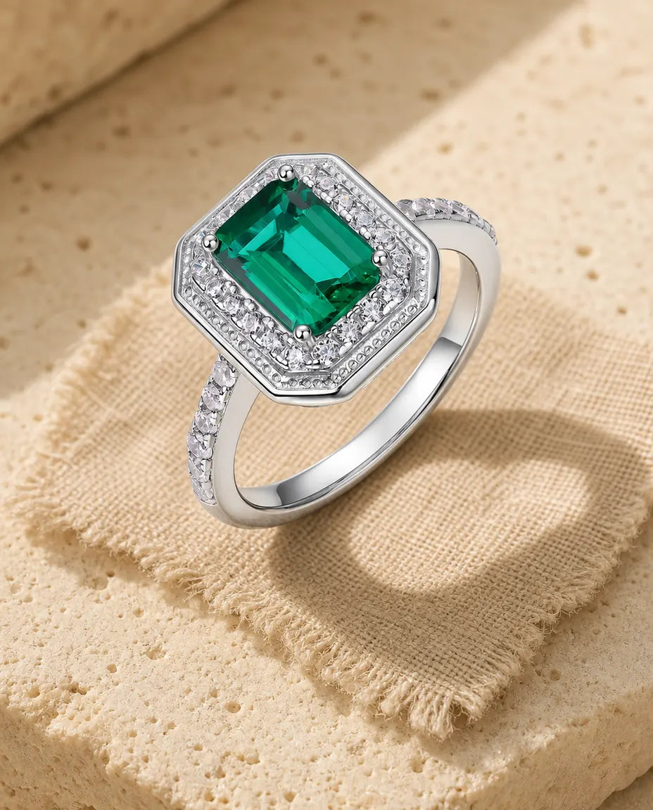 Lab emerald octagon halo ring in sterling silver with milgrain frame and pave band