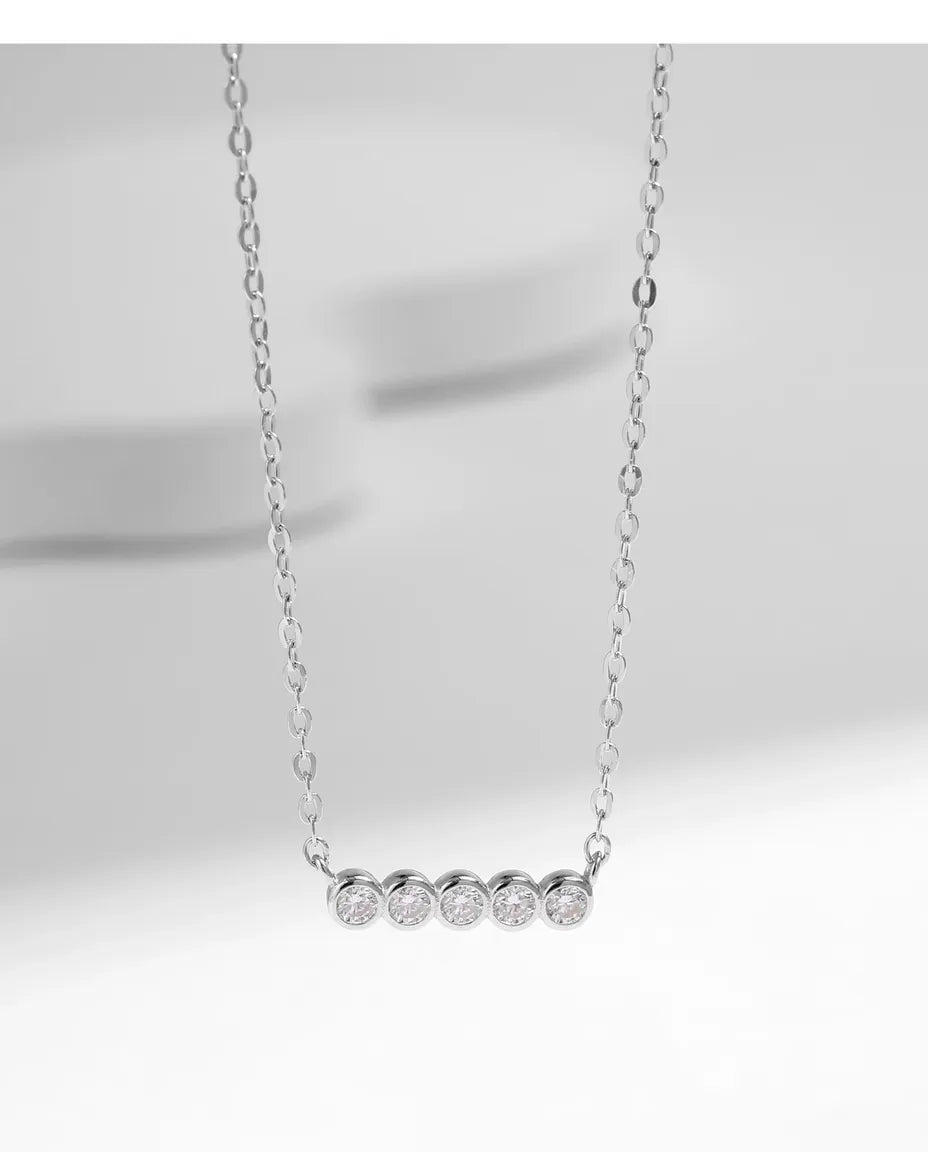 Moissanite bar necklace in 925 sterling silver, five D colour bezel-set stones, curved pendant for women